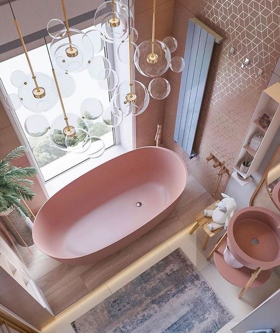 https://www.evdekorasyonum.com/wp-content/uploads/2023/09/a-cute-pink-bathroom-with-a-pink-bathtub-sink-tiled-walls-and-touches-of-gold-here-and-there.jpg